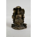 A Sino Tibetan bronze figure of Quan Yin, seated within a lotus flower, mark to the reverse