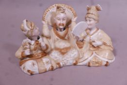 A Contintental bisque porcelain group of three oriental inspired figures with nodding heads and fan,