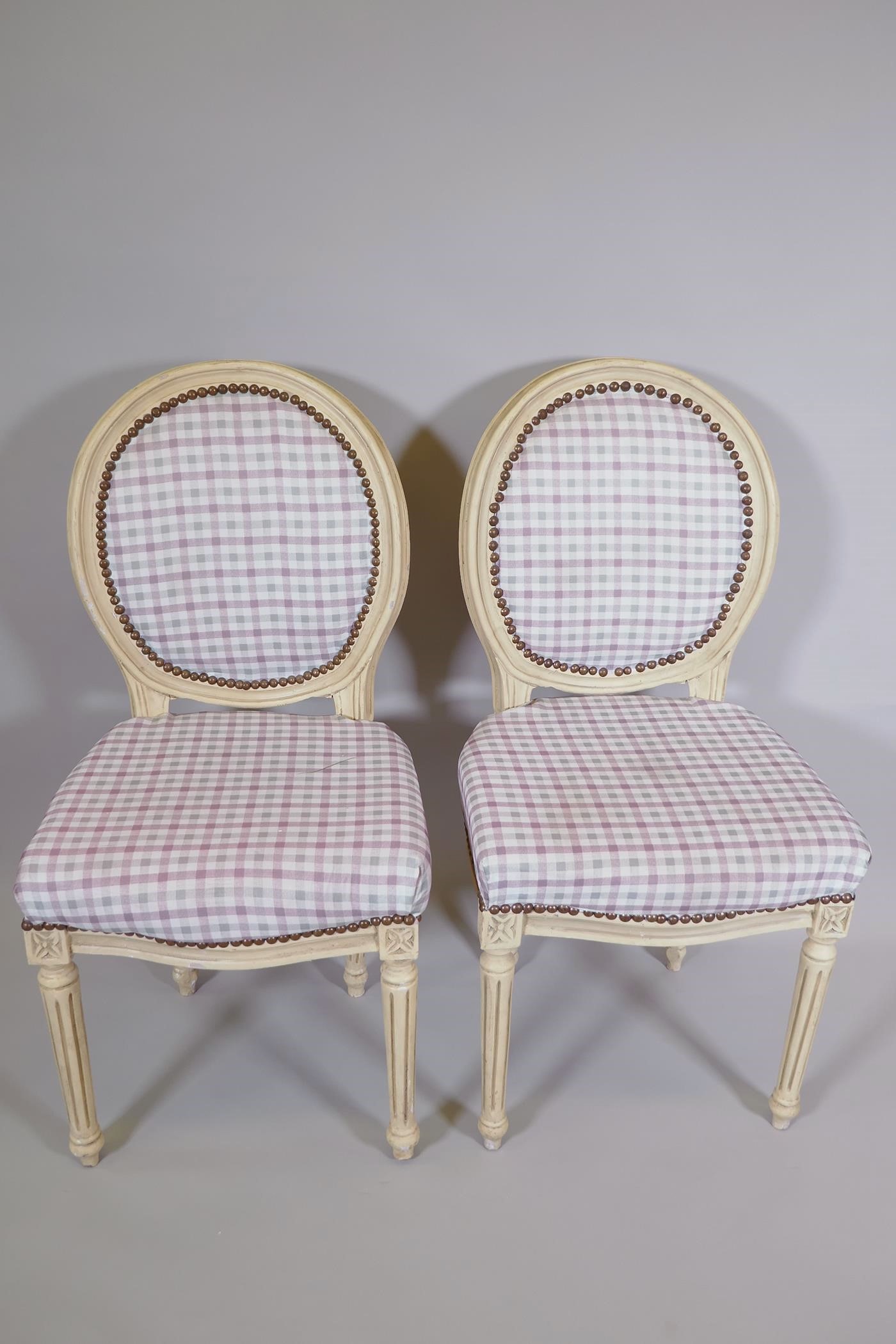 A pair of Victorian style balloon back chars with painted frames and Gingham upholstery