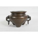 A C18th/C19th Chinese silver inlaid bronze censer on tripod supports wit two elephant mask