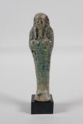 An Egyptian turquoise glazed faience shabti, 5" high