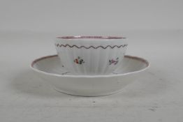 An C18th/C19th pearlware tea bowl and saucer of ribbed form, with floral decoration, 5" diameter