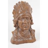 A carved hardwood bust of an American first Nation man, in chieftains head dress, 4½" high