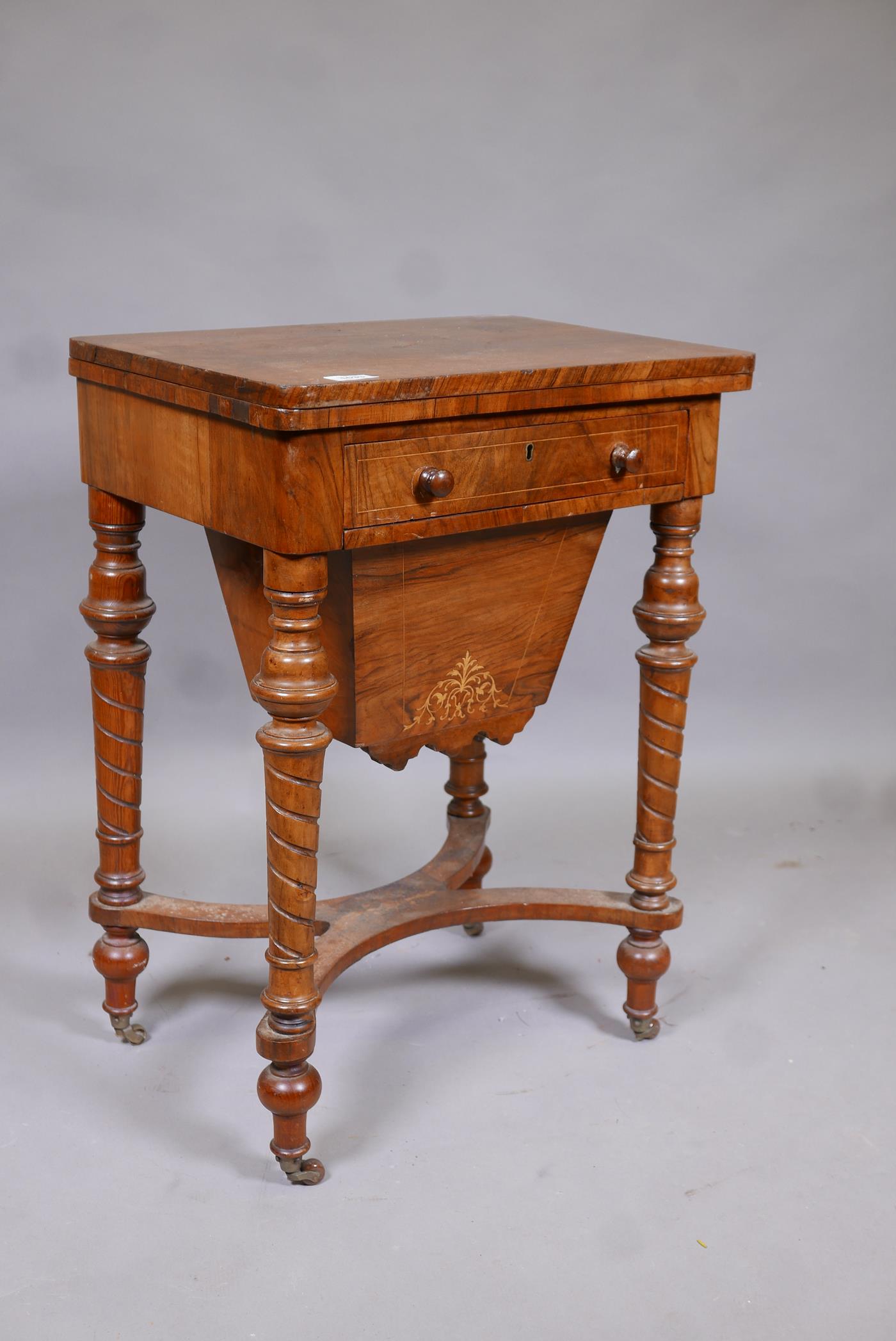 A C19th inlaid walnut work box, with fold out top inset with baize, frieze drawers and pull out
