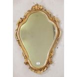 A carved and pierced giltwood rococo style wall mirror, early C20th, 35" long