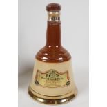 A sealed Wade Bells decanter, containing 75cms of Bell's Scotch Whisky 9½" high