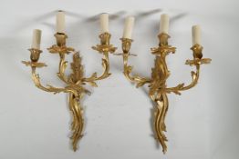 A pair of Rococo style ormolu three branch wall sconces, 18"