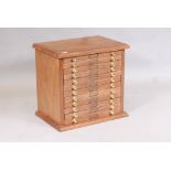 A walnut twelve drawer collector's cabinet, 21" x 15" x 20" high