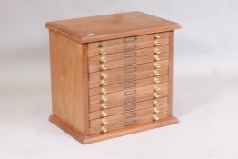 A walnut twelve drawer collector's cabinet, 21" x 15" x 20" high