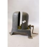 An antique milliners' metal hat stretcher, 13" high