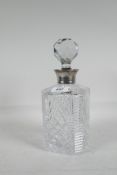 A cut glass decanter with silver mount, 10" high