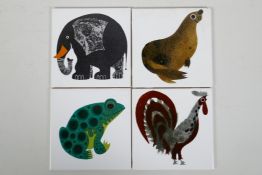 A set of four Kenneth Townsend porcelain tiles, depticting an elephant, frog, cockerel & seal