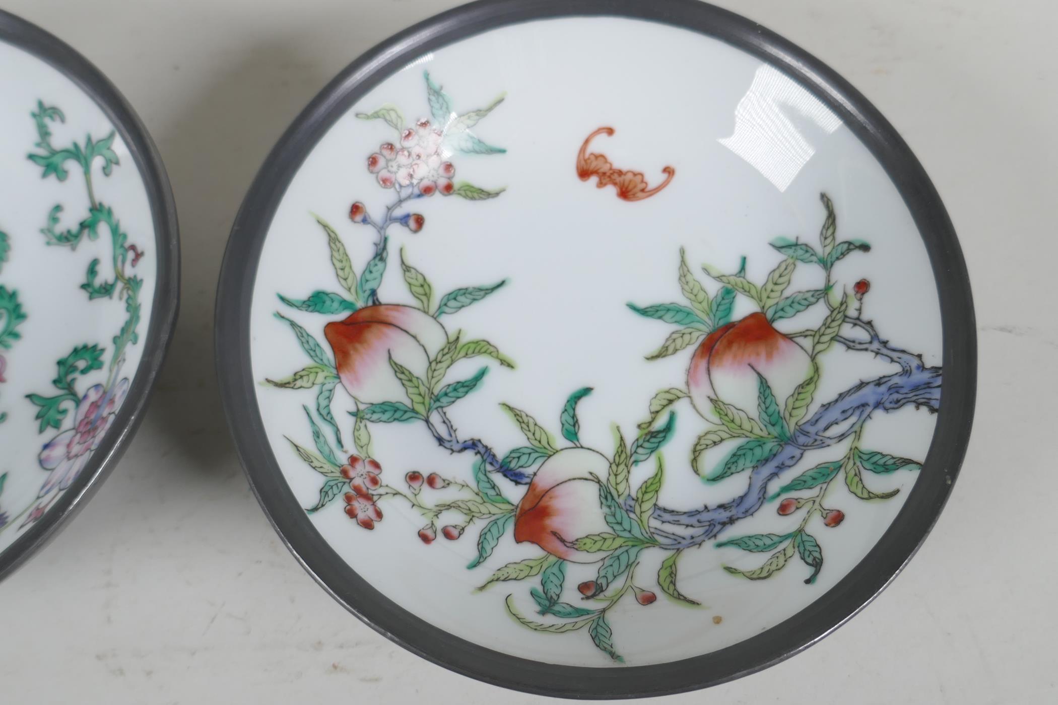 A pair of Chinese porcelain bowls painted with fruit flowers and bats, encassed in pewter frames. 6" - Image 3 of 4