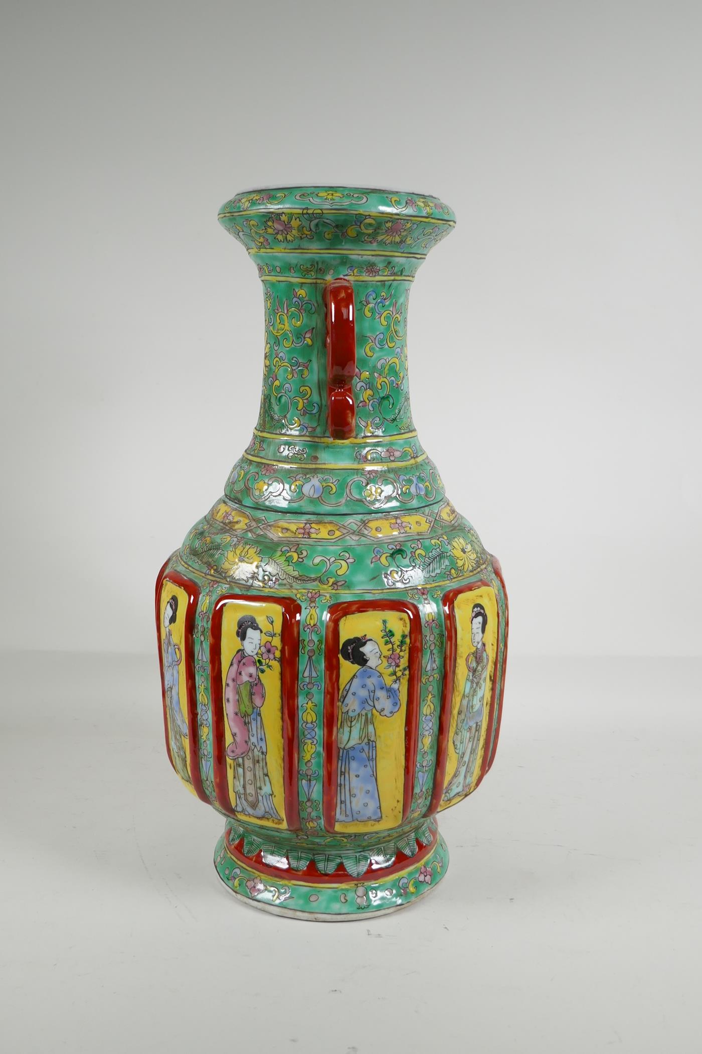 A Chinese polychrome porcelain two handled vase with raised decorative enamelled panels, depicting - Image 2 of 5