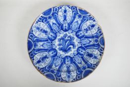 An C18th/C19th Delft blue and white charger with hand painted decoration, 13" diameter, A/F,