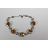 A 925 silver, cubic zirconia and citrine set bracelet, 7" long