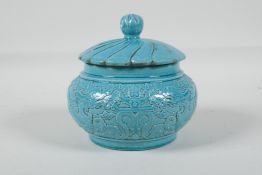 A Chinese turquoise glazed porcelain jar & cover, with raised stylised dragon decoration,