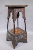 A C19th Moorish two tier stand of tapering form with all over carved decoration and Mother of