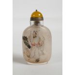 A Chinese reverse decorated glass snuff bottle depicting a wise man and his attendant, character