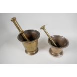 An antique brass mortar and pestle, 6" high, and another similar