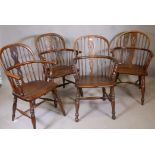 A harlequin set of four Windsor hoop back elbow chairs with elm seats