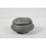A Chinese archaic style bronze censer & cover with raised wave decoration to cover, raised on tripod