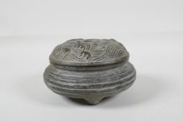 A Chinese archaic style bronze censer & cover with raised wave decoration to cover, raised on tripod