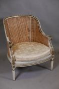 A C19th French tub shaped bergere chair, with double caned back and sides, and painted and parcel