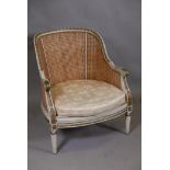 A C19th French tub shaped bergere chair, with double caned back and sides, and painted and parcel