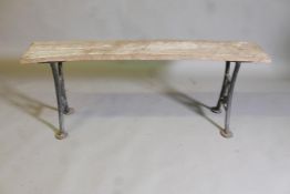 A plank top bench on wrought iron end supports, stamped Wake & Dean, London, 50" x 12" x 19"