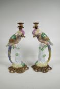 A pair of polychrome porcelain and gilt metal parakeet candlesticks, 16" high