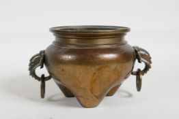 A C19th Chinese bronze censer on tripod supports with two elephant mask handles, 5" diameter