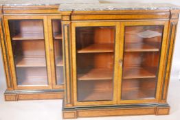 A pair of ebony inlaid amboyna inverted breakfront pier cabinets, with grey marble tops, two