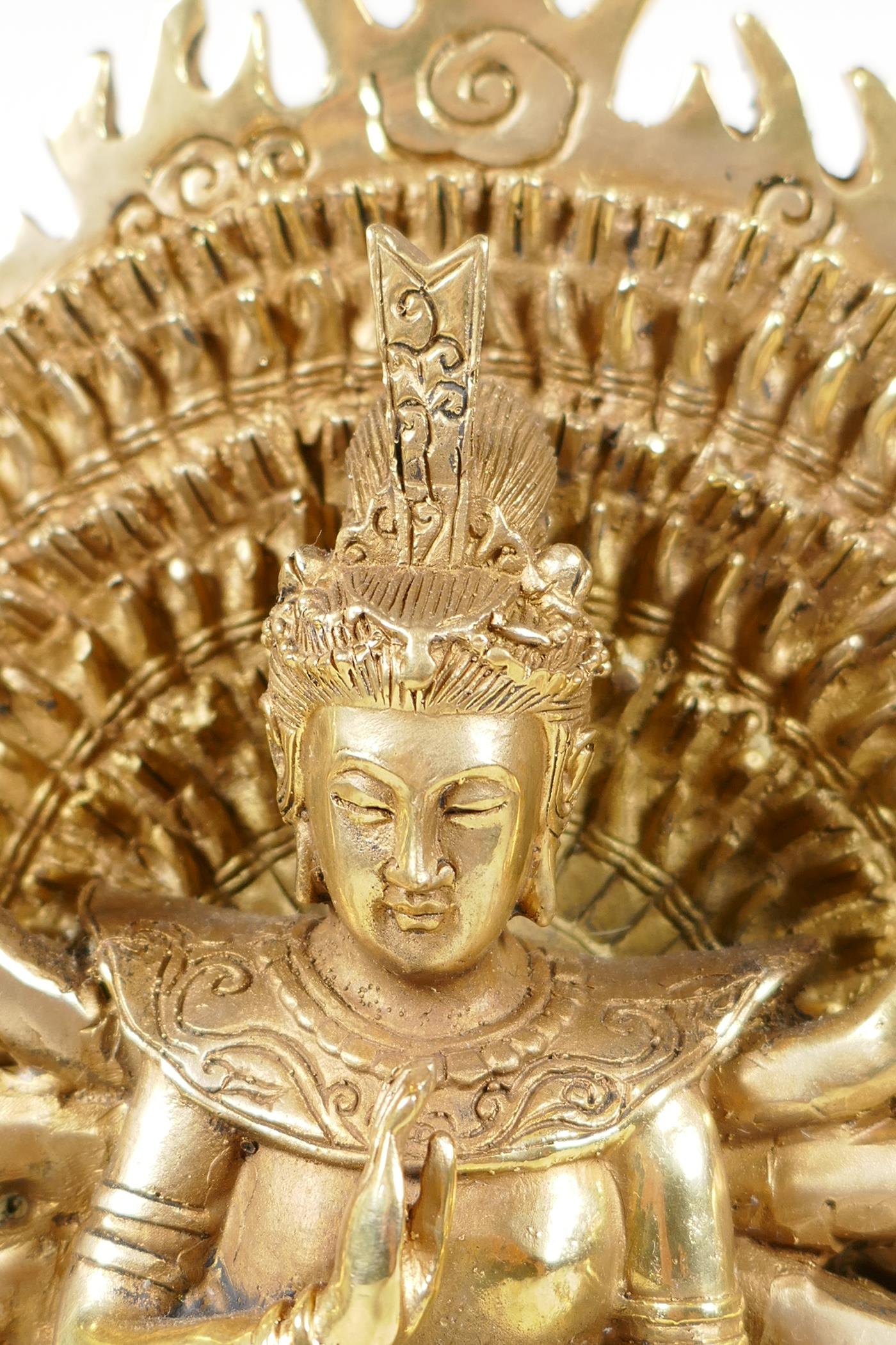 A Sino-Tibetan gilt bronze of a deity with many arms, on a lotus flower, 12½" high - Image 3 of 5