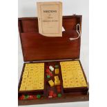 An oak box containing a mahjong set, complete with instructions