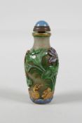 A Peking glass snuff bottle with carved & enamelled decoration of toads & waterfowl in a lotus pond,