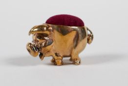 A coppered metal miniature pig pin cushion, 1" long