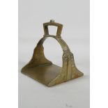 An Islamic brass stirrup, 5"