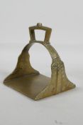 An Islamic brass stirrup, 5"