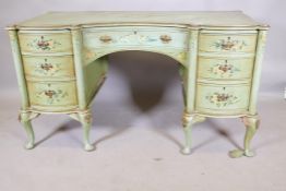 A continental serpentine front kneehole desk, with seven drawers, painted green and decorated with