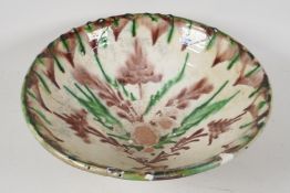 An antique Persian slip glazed wash bowl, 13½" diameter, (very A/F)