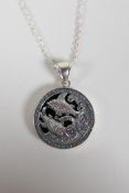 A sterling silver & onyx pendant necklace with Pisces star sign decoration, 1" diameter