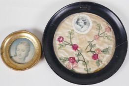 A 1920s embroidered mount with a picture of the Princess Elizabeth in a circular ebonised frame, 7½"