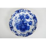 An C18th/C19th Delft blue and white charger with hand painted floral decoration, 14" diameter, A/F