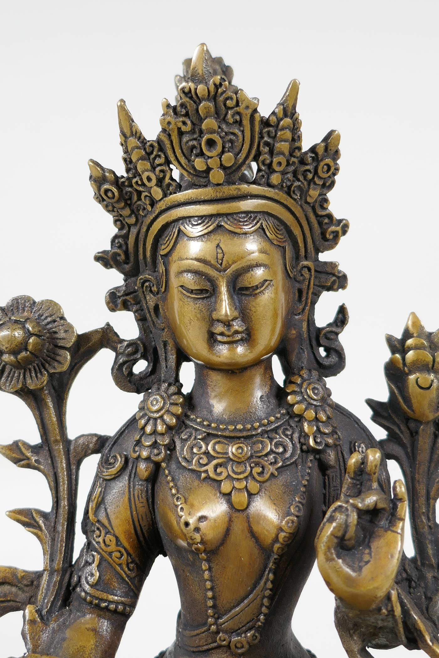 A Sino-Tibetan filled bronze of a deity seated on a lotus plinth, 8½" high - Image 2 of 4