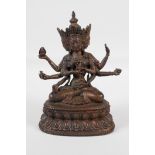 A Sino-Tibetan bronze of a many armed deity, seated on a lotus throne. Carrying auspicious items,