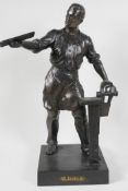 A bronzed white metal figure of a metal worker, 16" high