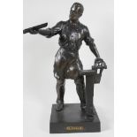 A bronzed white metal figure of a metal worker, 16" high