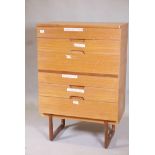 A mid century Uniflex teak six drawer chest with cup handles, raised on shaped supports, 30" x 18" x