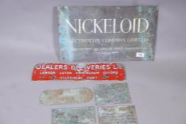 An enamel sign, 17" long, a bronze company name plate, and four machine plates